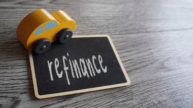 Toy car and text REFINANCE with copy space. Car loan refinancing concept